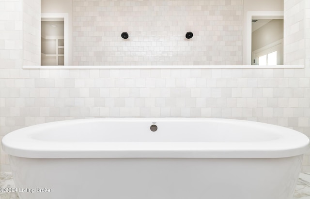 bathroom with a tub to relax in