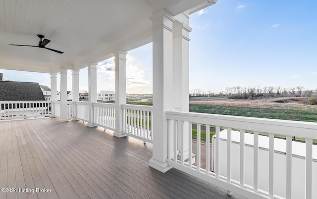 wooden deck featuring covered porch and ceiling fan