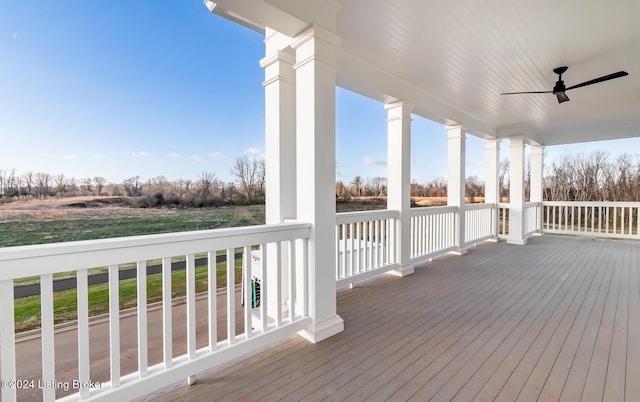 wooden terrace featuring ceiling fan and a porch