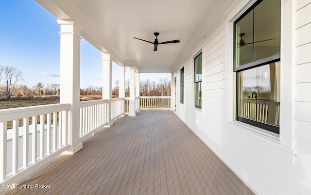 deck with ceiling fan and covered porch