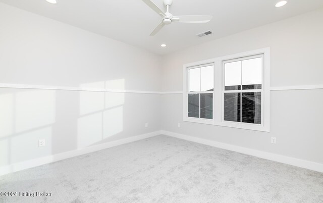 carpeted spare room featuring ceiling fan