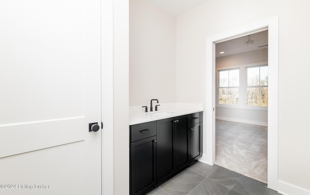 bathroom with tile patterned floors, vanity, and ceiling fan