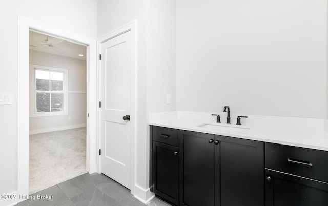 bathroom with ceiling fan and vanity