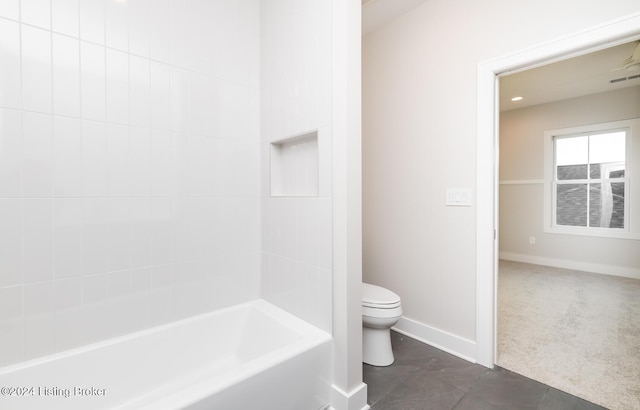 bathroom featuring tile patterned floors, shower / tub combination, and toilet