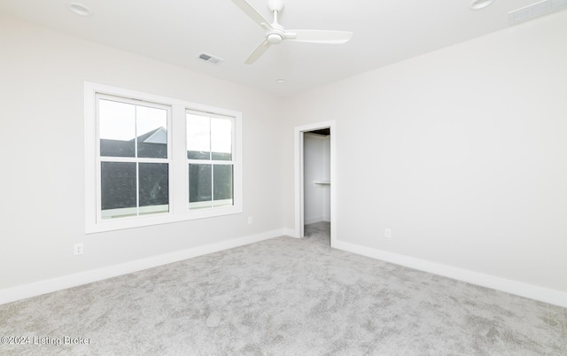 empty room with carpet flooring and ceiling fan