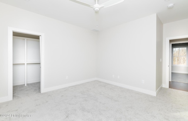 unfurnished bedroom with ceiling fan, light carpet, and a closet