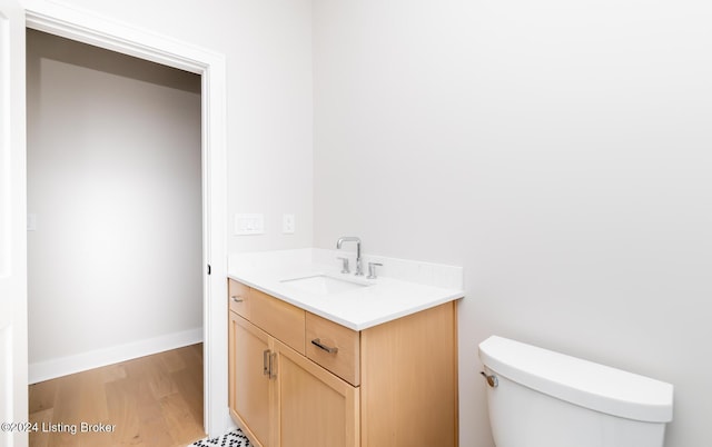 bathroom featuring hardwood / wood-style flooring, vanity, and toilet