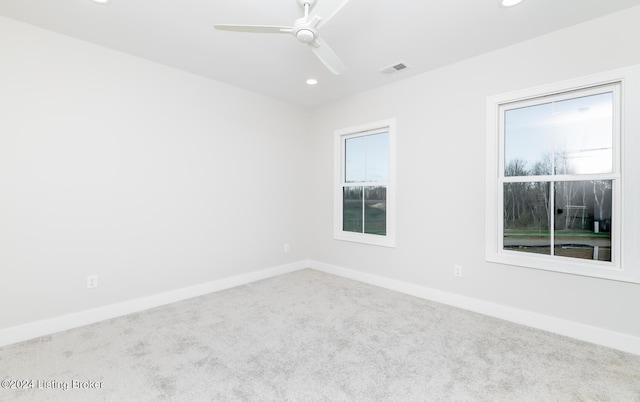 empty room with ceiling fan and carpet floors