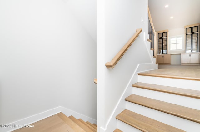 staircase with wood-type flooring