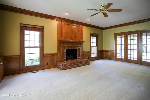 9602 Moorfield Cir, Louisville, KY 40241 - unfurnished living room with a wainscoted wall, light carpet, crown molding, a fireplace, and ceiling fan