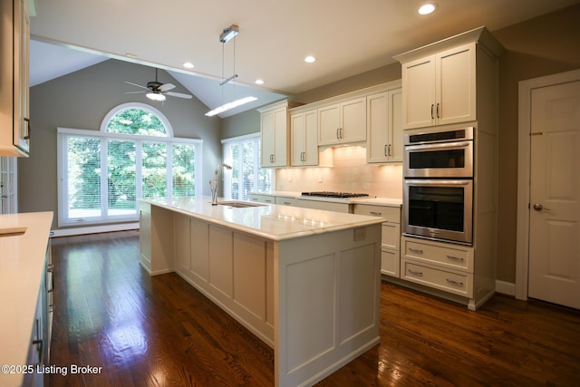 9602 Moorfield Cir, Louisville, KY 40241 - kitchen with a sink, a ceiling fan, stainless steel double oven, dark wood-style floors, and lofted ceiling