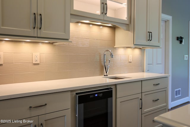 9602 Moorfield Cir, Louisville, KY 40241 - kitchen featuring wine cooler, a sink, tasteful backsplash, and light countertops
