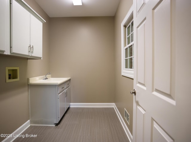 9602 Moorfield Cir, Louisville, KY 40241 - laundry room featuring baseboards, washer hookup, and cabinet space