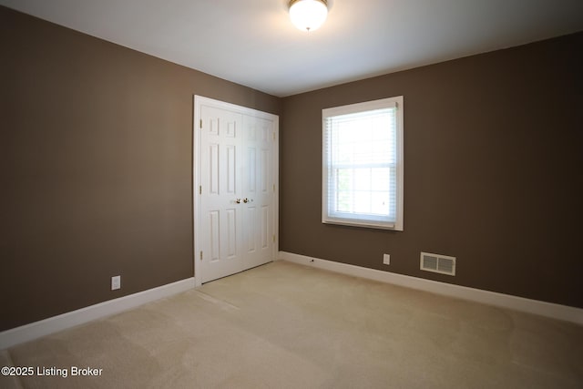 9602 Moorfield Cir, Louisville, KY 40241 - unfurnished bedroom featuring light colored carpet, baseboards, and a closet