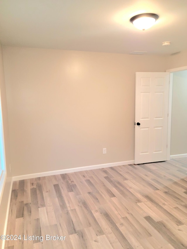 empty room with light hardwood / wood-style flooring