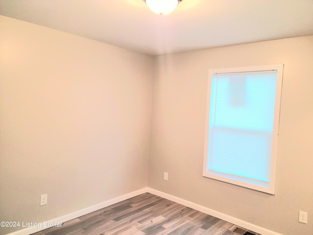 empty room with hardwood / wood-style floors