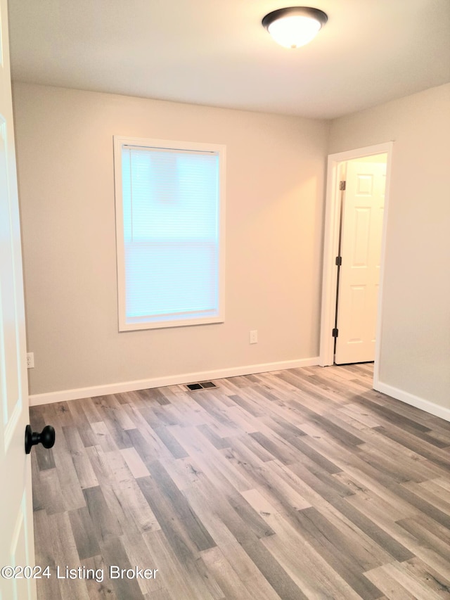 unfurnished room featuring hardwood / wood-style flooring