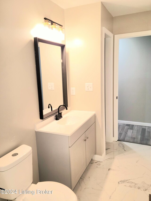 bathroom featuring vanity and toilet