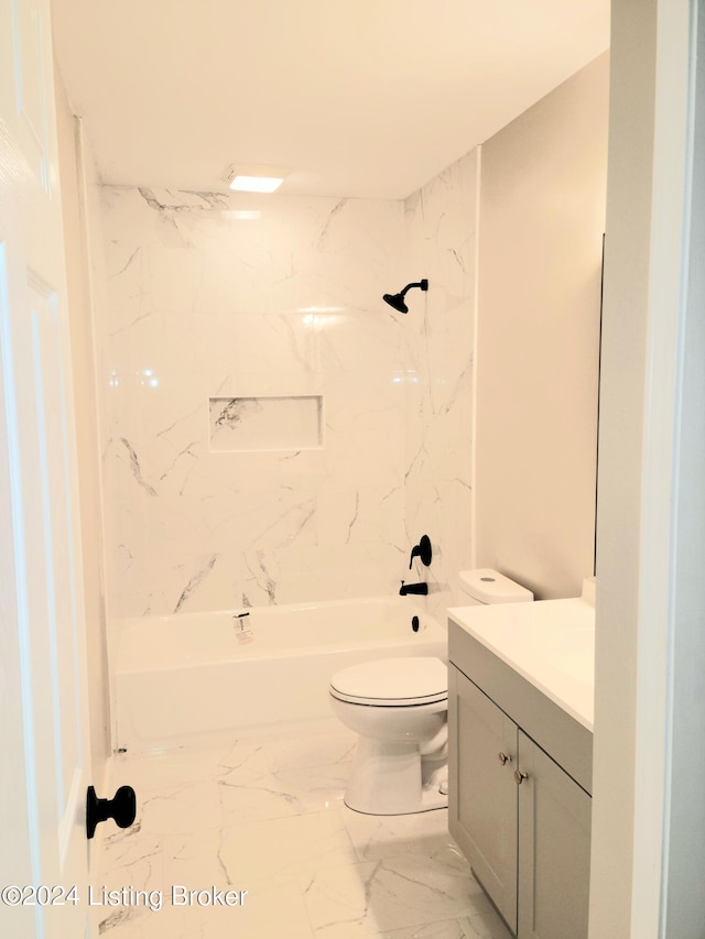 full bathroom featuring tiled shower / bath combo, vanity, and toilet