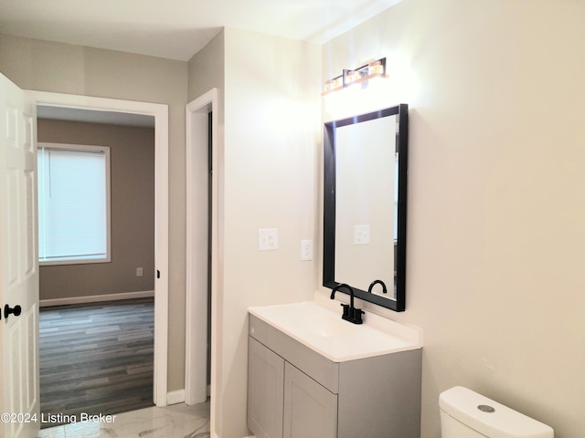 bathroom featuring hardwood / wood-style floors, vanity, and toilet