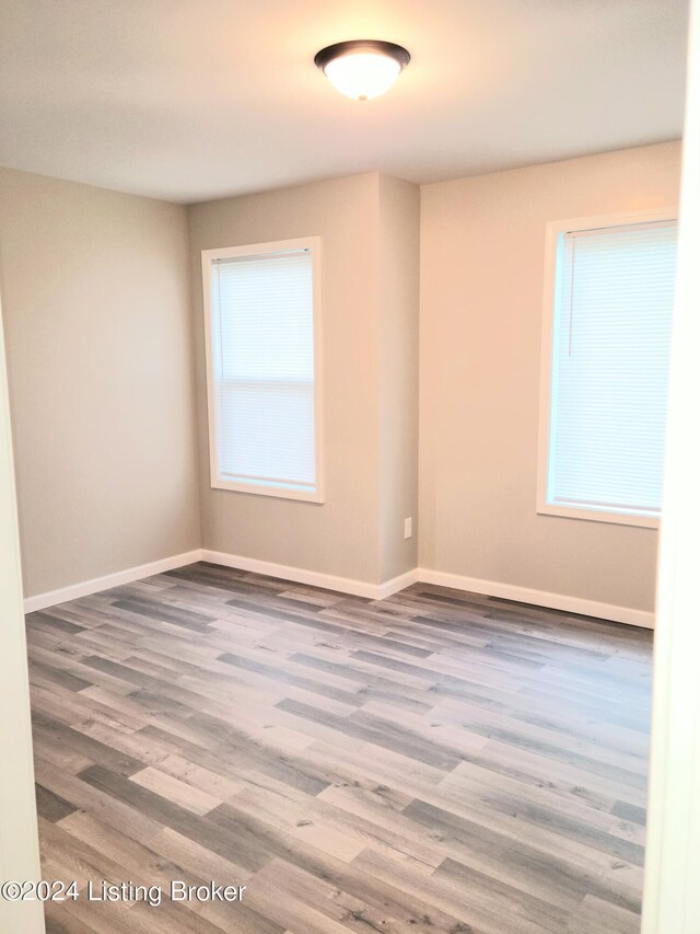 unfurnished room featuring hardwood / wood-style flooring