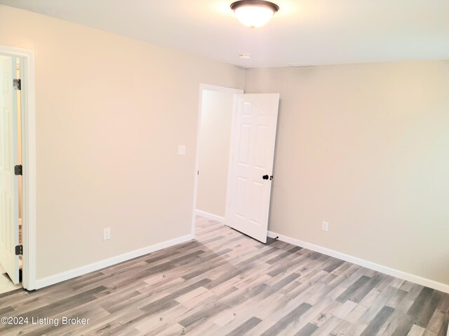 spare room featuring light wood-type flooring