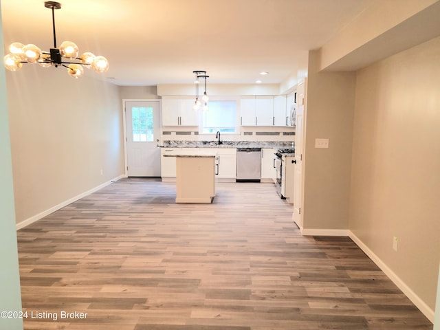 kitchen featuring white cabinets, stainless steel appliances, light wood-type flooring, and a kitchen island