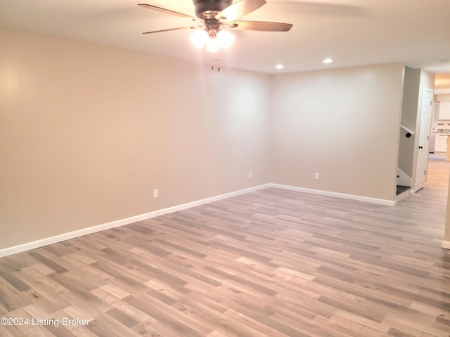 unfurnished room with ceiling fan and light hardwood / wood-style flooring