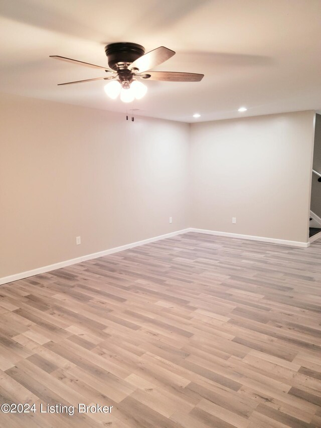 empty room with ceiling fan and light wood-type flooring