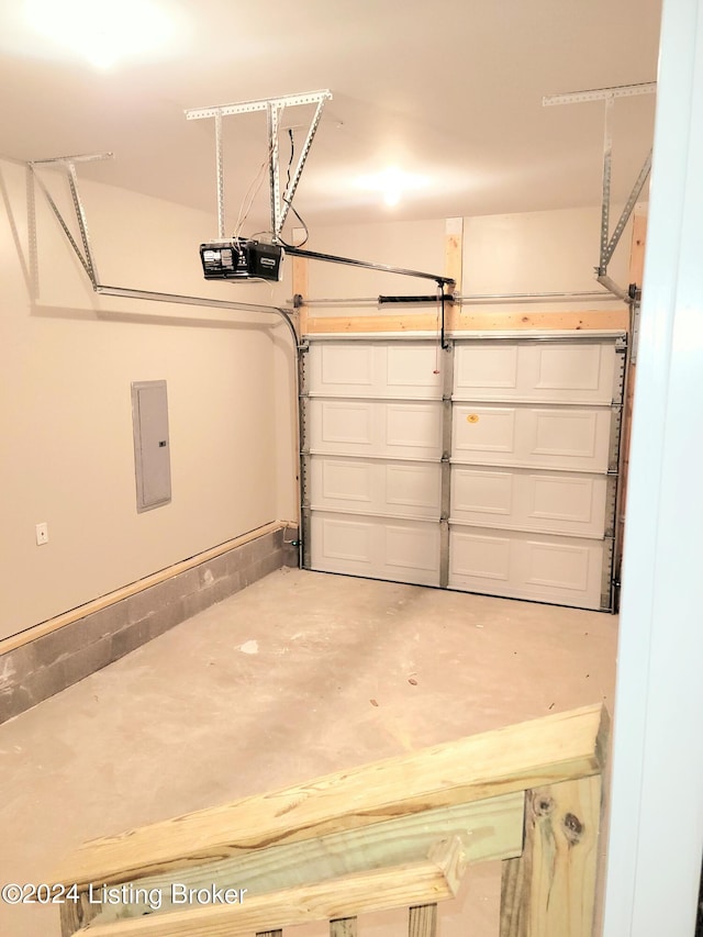 garage with a garage door opener and electric panel