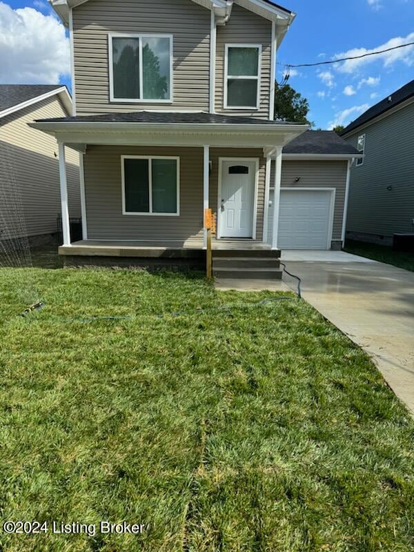 front of property featuring a front lawn, a porch, and a garage