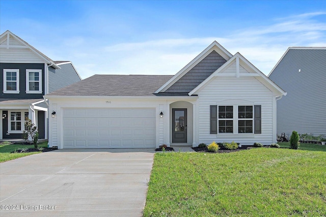 view of front of house with a garage and a front yard