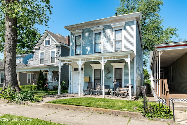 italianate home featuring covered porch