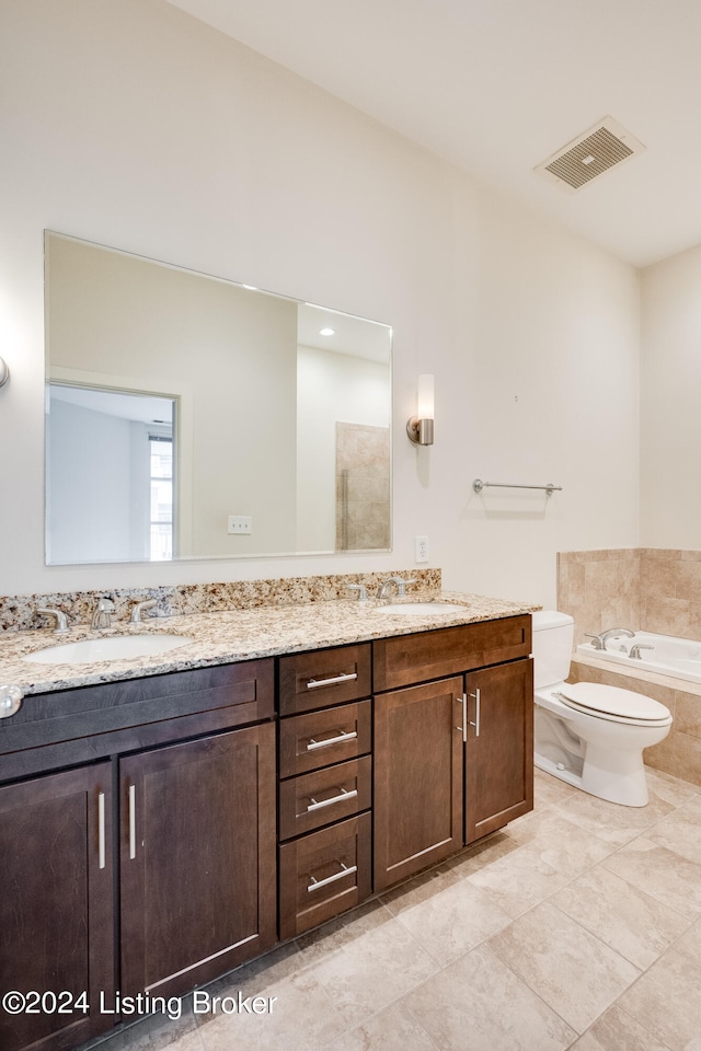 bathroom with a tub, tile flooring, double sink, and large vanity