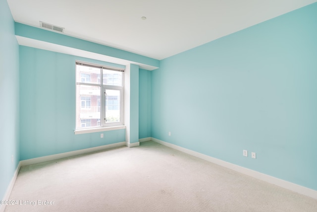 unfurnished room featuring carpet and a healthy amount of sunlight