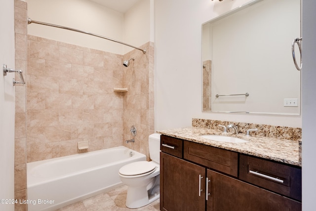 full bathroom featuring tile flooring, tiled shower / bath combo, vanity, and toilet