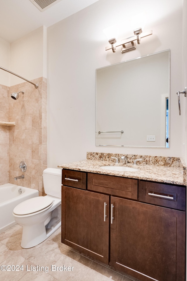 full bathroom featuring tile flooring, tiled shower / bath, vanity, and toilet