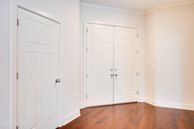 foyer featuring ornamental molding and hardwood / wood-style flooring