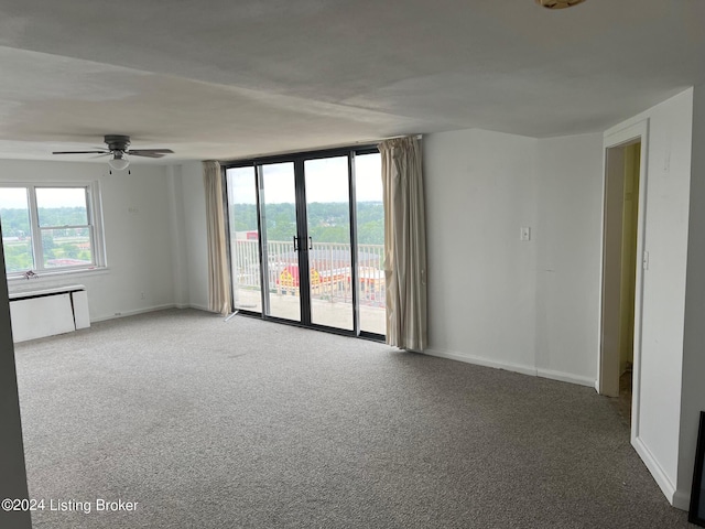 unfurnished room with french doors and carpet