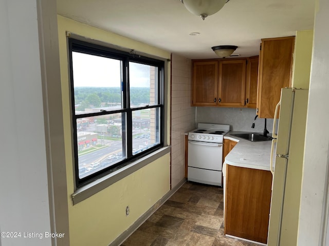 kitchen with sink, backsplash, and white appliances