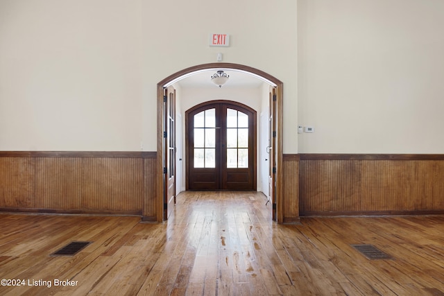 entrance foyer featuring a high ceiling, french doors, and hardwood / wood-style flooring