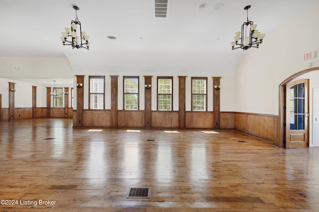 interior space featuring vaulted ceiling, hardwood / wood-style flooring, and a chandelier