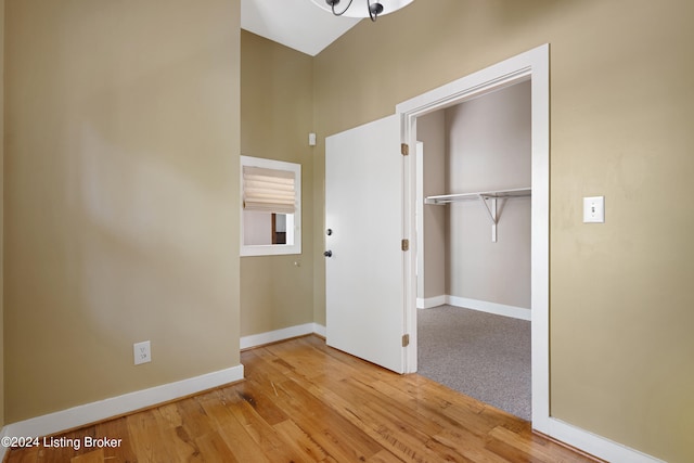 unfurnished bedroom with a closet and light hardwood / wood-style flooring