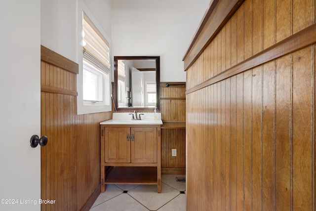 bathroom with vanity with extensive cabinet space and tile flooring