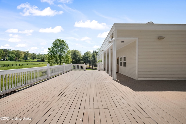 wooden terrace with a yard