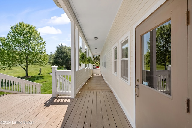 wooden terrace with a lawn