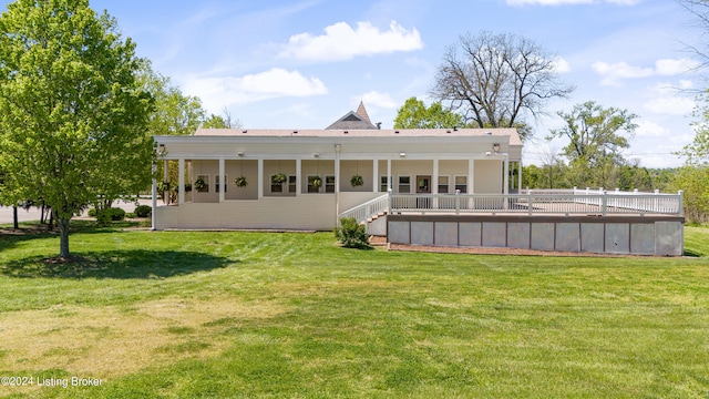 rear view of house featuring a lawn