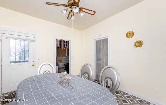 dining room with a textured ceiling and ceiling fan