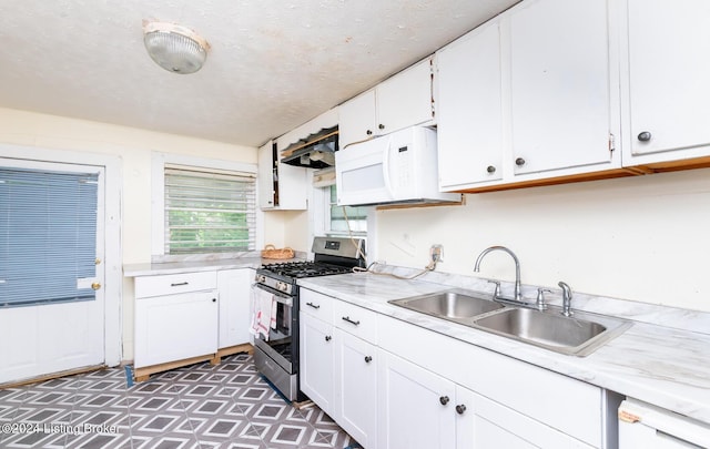 kitchen with sink, white cabinets, exhaust hood, and white appliances