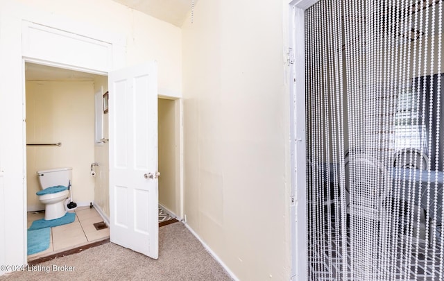 bathroom with tile patterned flooring and toilet